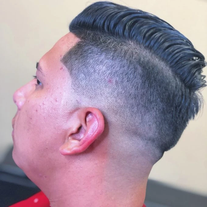 Swept-back hairstyle with a close tapered side